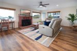 The living room features ample seating and cozy fire place.